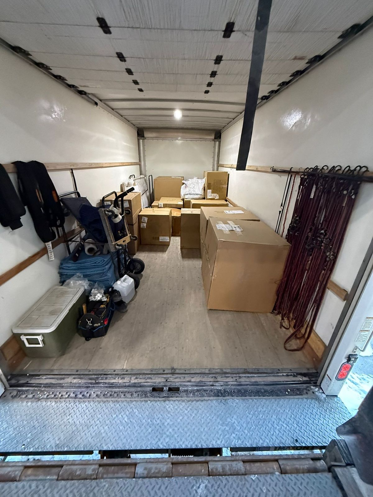 Organised truck load with dollies and moving blankets