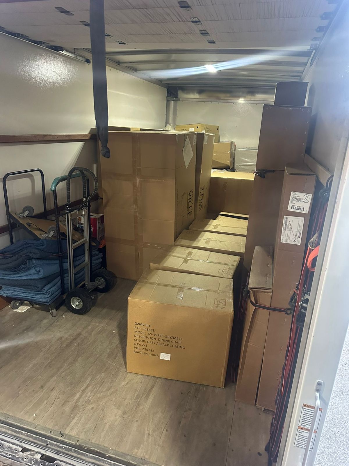 Boxed furniture secured in a delivery truck