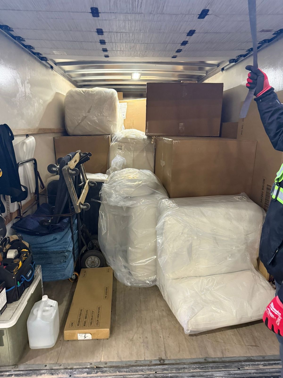 Wrapped sofas and boxes loaded for delivery