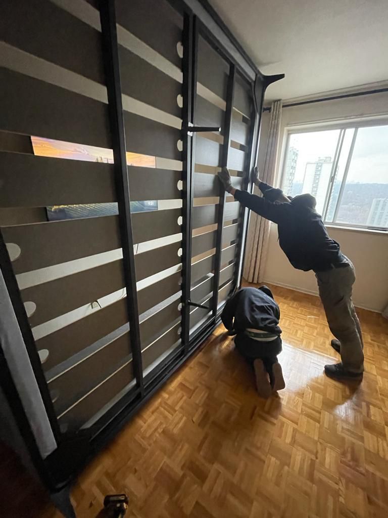 Crew installing a wall bed in a Toronto condo